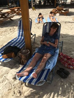 Photo of Barbados - in the shade My wife napping in the shaded beach chair under one of the tiki-hut style covers , tnyankfan - July 2016
