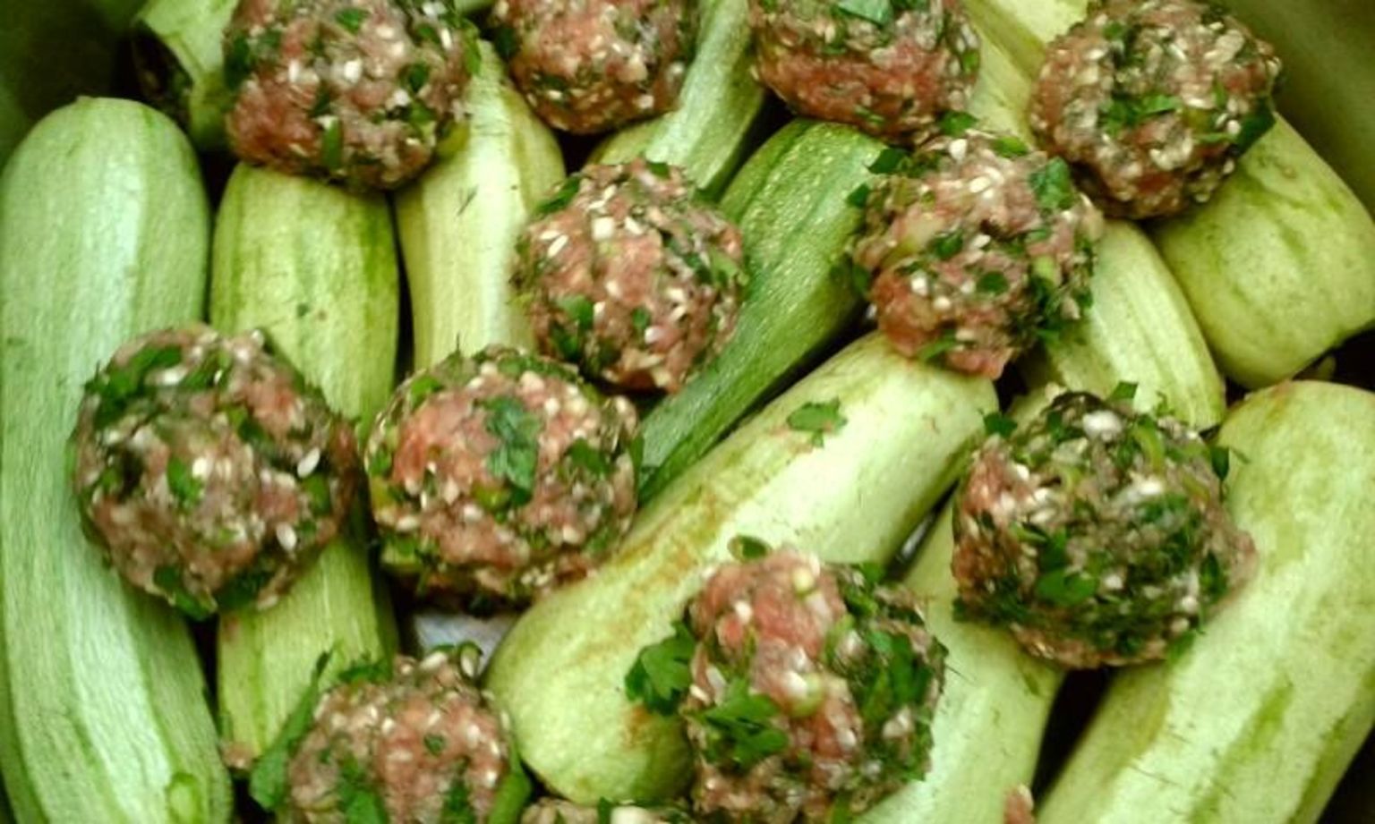 Zucchini stuffed with minced meat, rice, and herbs