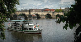 Photo of The Charles Bridge and Vlatava River, from Kampa Park This is one of the many river boats (not the kind used for the tour under review) that are a common sight. , Norm - May 2014