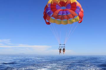 Round trip transfers to West Bay Beach with Parasailing included