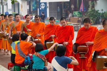 Alms giving ceremony and morning market with taste of local food and dinks