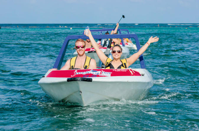 cancun jungle tour adventure speed boat snorkeling fun smiling hands arms up in air sky